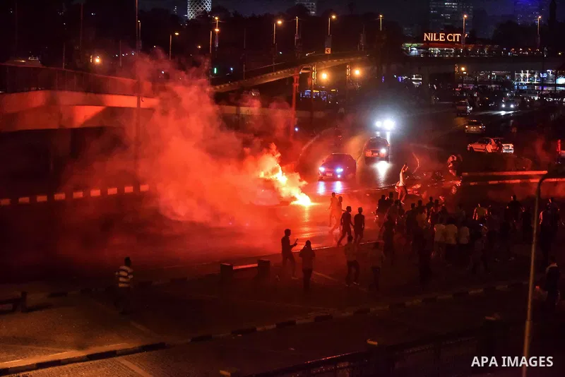 Members of Ultras Nahdawy group, who are supporters of the Muslim Brotherhood and ousted President Mohamed Morsi, light flares and shout slogans during a demonstration against military rule at Abdel Moneim Riad Square in...