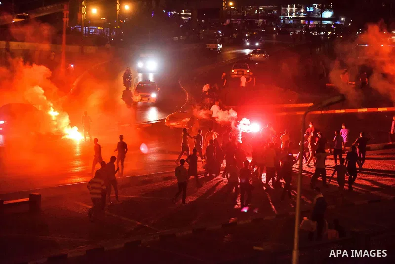 Members of Ultras Nahdawy group, who are supporters of the Muslim Brotherhood and ousted President Mohamed Morsi, light flares and shout slogans during a demonstration against military rule at Abdel Moneim Riad Square in...
