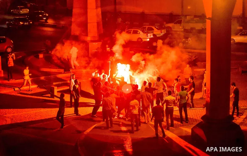 Members of Ultras Nahdawy group, who are supporters of the Muslim Brotherhood and ousted President Mohamed Morsi, light flares and shout slogans during a demonstration against military rule at Abdel Moneim Riad Square in...