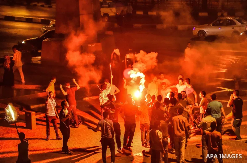 Members of Ultras Nahdawy group, who are supporters of the Muslim Brotherhood and ousted President Mohamed Morsi, light flares and shout slogans during a demonstration against military rule at Abdel Moneim Riad Square in...