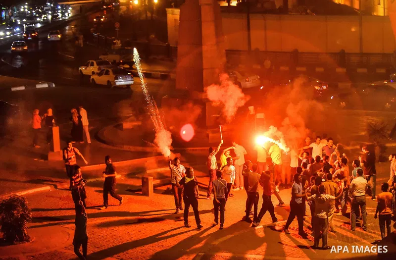Members of Ultras Nahdawy group, who are supporters of the Muslim Brotherhood and ousted President Mohamed Morsi, light flares and shout slogans during a demonstration against military rule at Abdel Moneim Riad Square in...