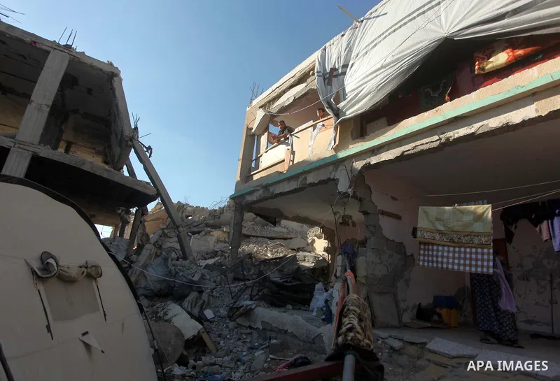A Palestinian woman works on the rubble of a building that was destroyed during 50-day Israeli on Gaza Strip in the summer of 2014, east of Khan Younis in the southern Gaza Strip on June 22, 2015. A widely anticipated Un...
