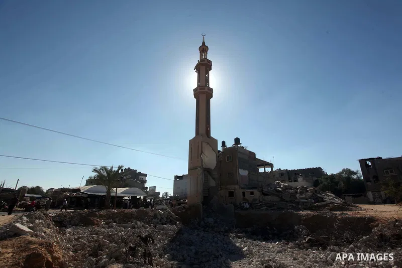 Palestinians walk near the rubble of a mosque that was destroyed during 50-day Israeli on Gaza Strip in the summer of 2014, east of Khan Younis in the southern Gaza Strip on June 22, 2015. A widely anticipated United Nat...