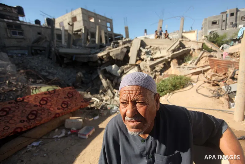 A Palestinian man stands on the rubble of a building that was destroyed during 50-day Israeli on Gaza Strip in the summer of 2014, east of Khan Younis in the southern Gaza Strip on June 22, 2015. A widely anticipated Uni...