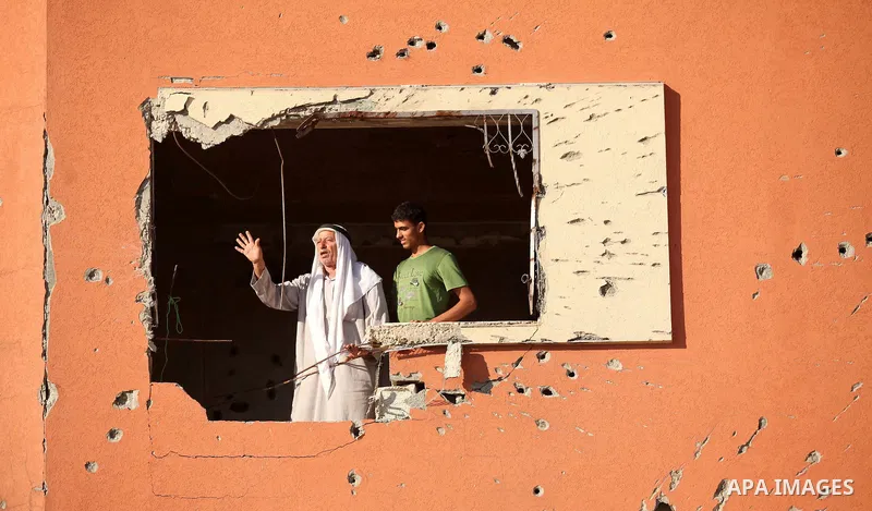 Palestinians stand on the remains of a building that was destroyed during 50-day Israeli on Gaza Strip in the summer of 2014, east of Khan Younis in the southern Gaza Strip on June 22, 2015. A widely anticipated United N...
