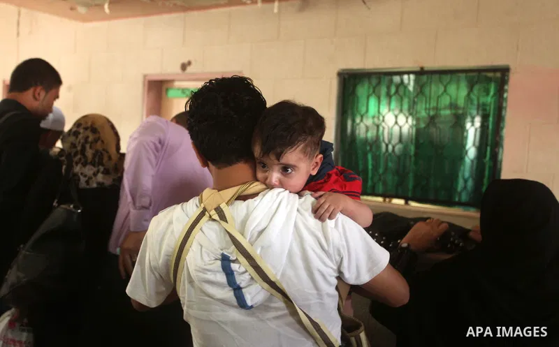 Palestinians wait for travel permits to cross into Egypt at the Rafah border crossing between Egypt and southern Gaza Strip June 23, 2015. Egyptian authorities last week decided to open the Rafah crossing to allow Palest...