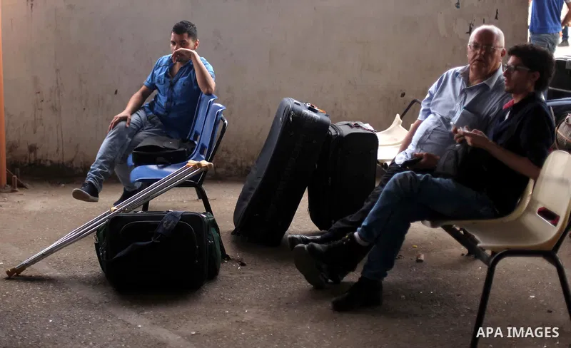 Palestinians wait for travel permits to cross into Egypt at the Rafah border crossing between Egypt and southern Gaza Strip June 23, 2015. Egyptian authorities last week decided to open the Rafah crossing to allow Palest...