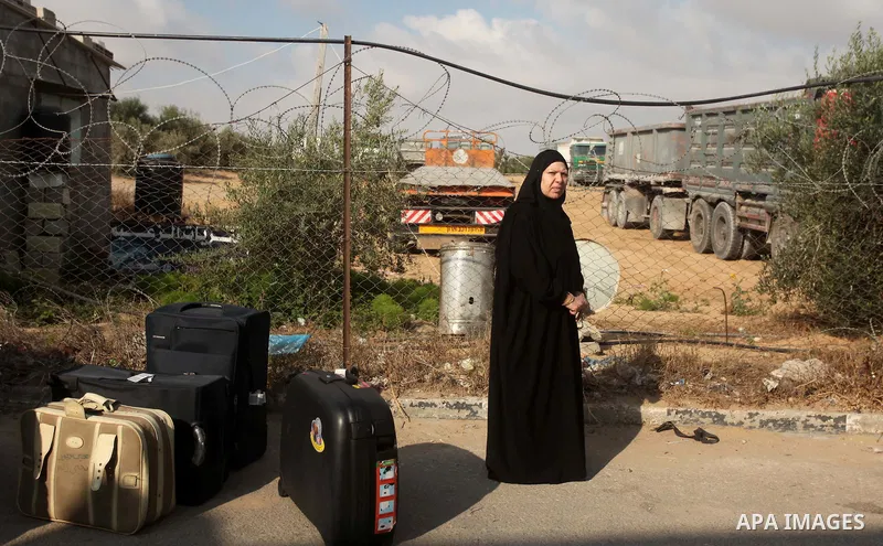 Palestinians wait for travel permits to cross into Egypt at the Rafah border crossing between Egypt and southern Gaza Strip June 23, 2015. Egyptian authorities last week decided to open the Rafah crossing to allow Palest...