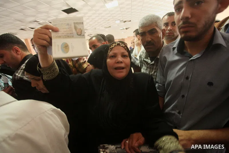 Palestinians wait for travel permits to cross into Egypt at the Rafah border crossing between Egypt and southern Gaza Strip June 23, 2015. Egyptian authorities last week decided to open the Rafah crossing to allow Palest...