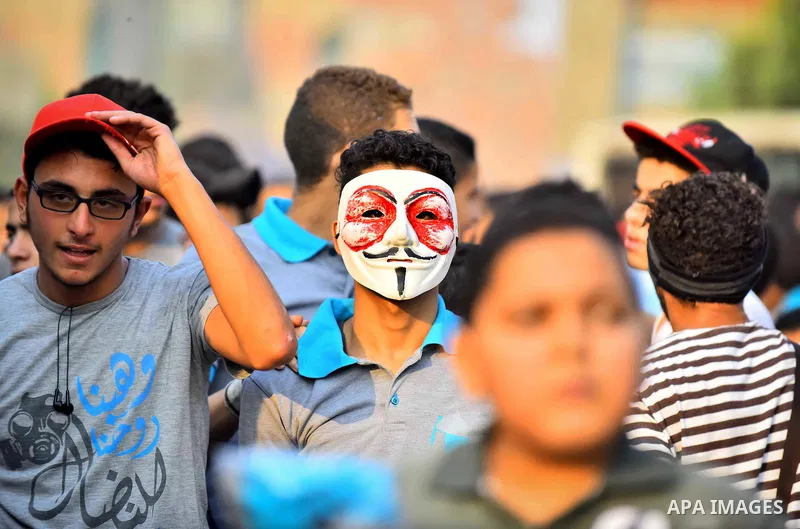 Members of Ultras Nahdawy group, who are supporters of the Muslim Brotherhood and ousted President Mohamed Morsi, light flares and shout slogans during a demonstration against military rule in Cairo, on June 23, 2015. Ph...