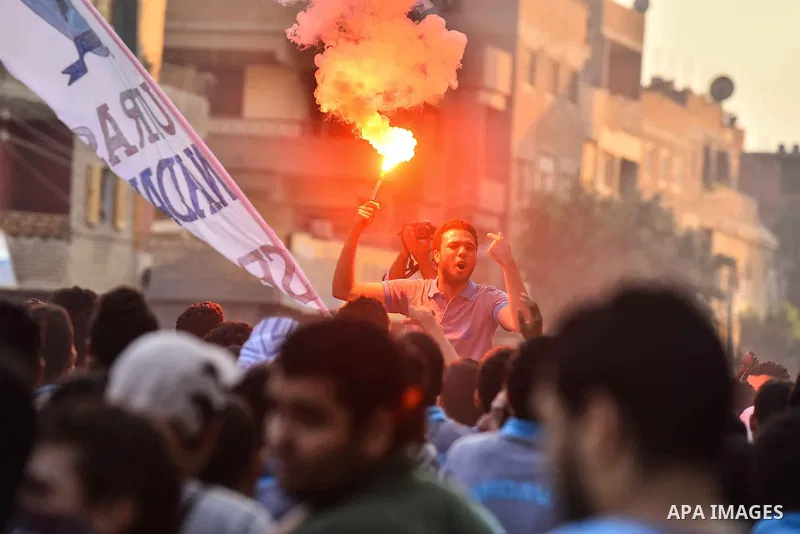 Members of Ultras Nahdawy group, who are supporters of the Muslim Brotherhood and ousted President Mohamed Morsi, light flares and shout slogans during a demonstration against military rule in Cairo, on June 23, 2015. Ph...