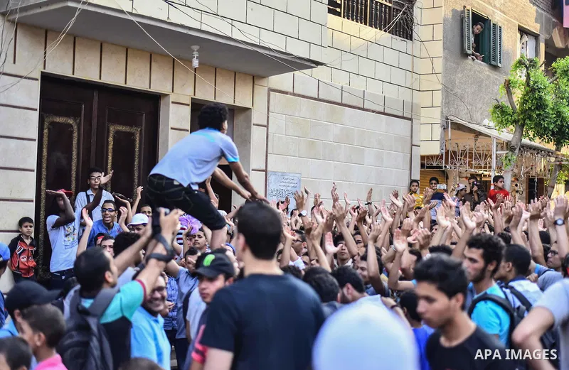 Members of Ultras Nahdawy group, who are supporters of the Muslim Brotherhood and ousted President Mohamed Morsi, light flares and shout slogans during a demonstration against military rule in Cairo, on June 23, 2015. Ph...