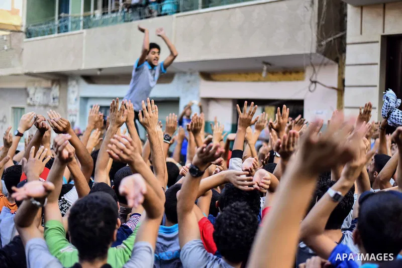 Members of Ultras Nahdawy group, who are supporters of the Muslim Brotherhood and ousted President Mohamed Morsi, light flares and shout slogans during a demonstration against military rule in Cairo, on June 23, 2015. Ph...