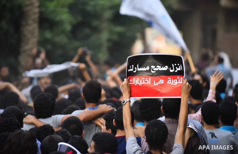 Members of Ultras Nahdawy group, who are supporters of the Muslim Brotherhood and ousted President Mohamed Morsi, light flares and shout slogans during a demonstration against military rule in Cairo, on June 23, 2015. Ph...
