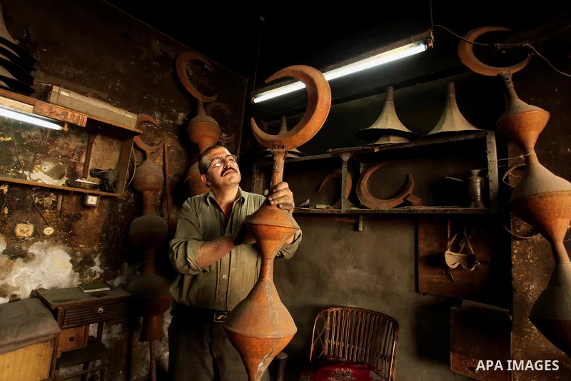 A Palestinian copper, Mohammed Abdo 53, works at his workshop, in Gaza city, on June 24, 2015. Abdo inherited copper profession from his father for nearly 40 years. Make replicas Crescent attached to mosques. He is the o...