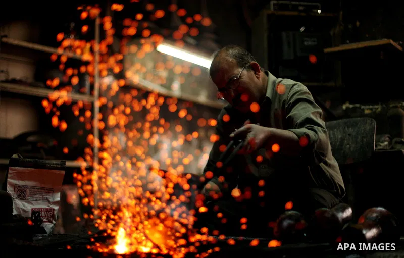 A Palestinian copper, Mohammed Abdo 53, works at his workshop, in Gaza city, on June 24, 2015. Abdo inherited copper profession from his father for nearly 40 years. Make replicas Crescent attached to mosques. He is the o...