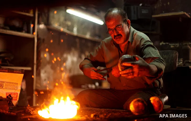 A Palestinian copper, Mohammed Abdo 53, works at his workshop, in Gaza city, on June 24, 2015. Abdo inherited copper profession from his father for nearly 40 years. Make replicas Crescent attached to mosques. He is the o...