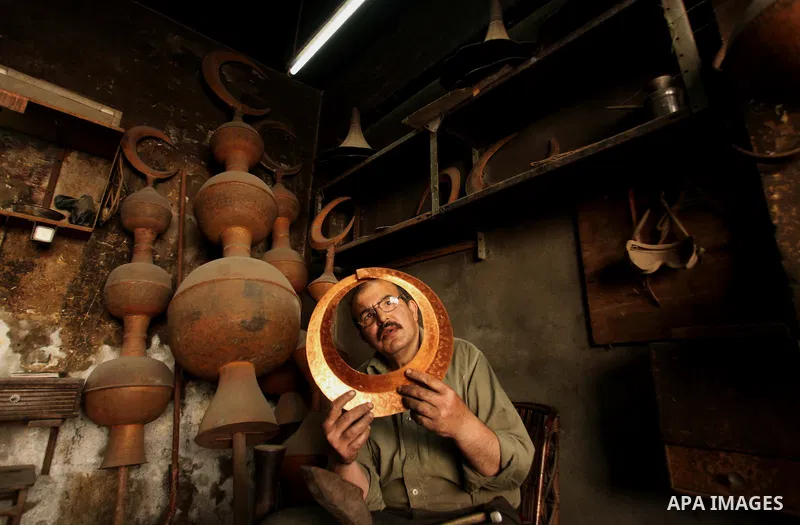 A Palestinian copper, Mohammed Abdo 53, works at his workshop, in Gaza city, on June 24, 2015. Abdo inherited copper profession from his father for nearly 40 years. Make replicas Crescent attached to mosques. He is the o...
