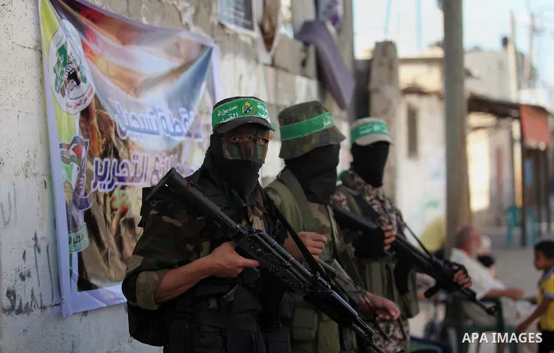 Members of Izzedine al-Qassam brigades, loyal to Hamas movement stand guard during register for the summer camps in Dair Al Balah in the center of Gaza strip on June 25, 2015. Photo by Ashraf Amra