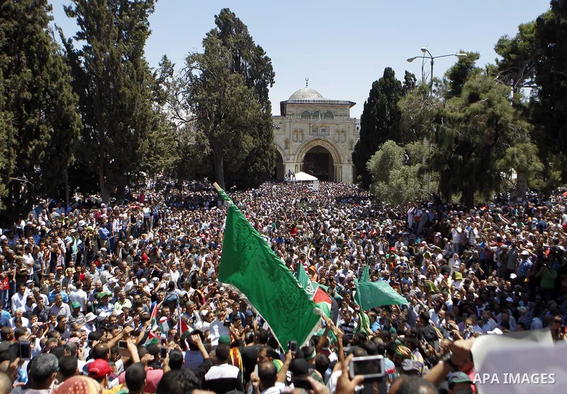 Palestinian Muslim worshipers shout slogans during a demonstration to support prisoner Khader Adnan, a senior member of the Islamic Jihad who was jailed in Israel without a trial, following Friday prayers at the Al-Aqsa...