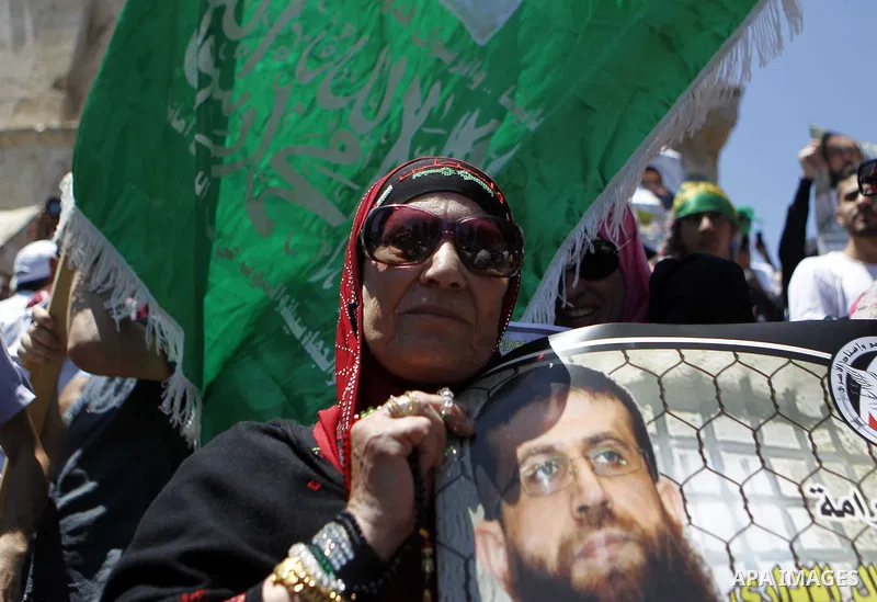 Palestinian Muslim worshipers shout slogans during a demonstration to support prisoner Khader Adnan, a senior member of the Islamic Jihad who was jailed in Israel without a trial, following Friday prayers at the Al-Aqsa...