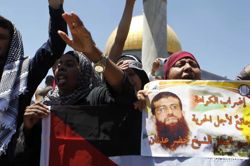 Palestinian Muslim worshipers shout slogans during a demonstration to support prisoner Khader Adnan, a senior member of the Islamic Jihad who was jailed in Israel without a trial, following Friday prayers at the Al-Aqsa...