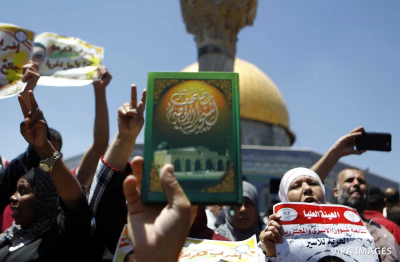 Palestinian Muslim worshipers shout slogans during a demonstration to support prisoner Khader Adnan, a senior member of the Islamic Jihad who was jailed in Israel without a trial, following Friday prayers at the Al-Aqsa...
