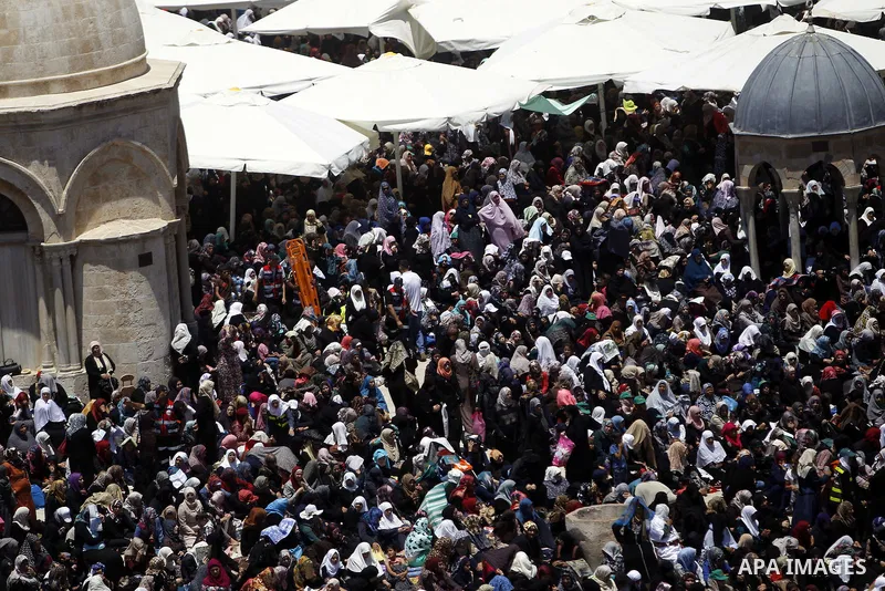 Palestinian Muslim worshipers pray outside the Dome of the Rock at the Al-Aqsa Mosque compound in Jerusalem during the second Friday prayer of the holy month of Ramadan, on June 26, 2015. Photo by Saeb Awad