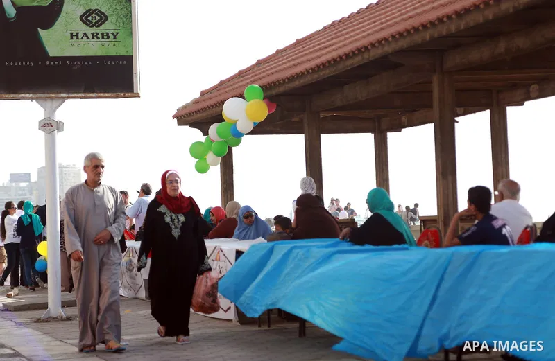 Egyptians gather around an Iftar table as they wait to break their daytime fast, during the Muslim holy month of Ramadan, in Egypt s Mediterranean city of Alexandria, Friday, June 26, 2015. Alexandria is seeking to enter...