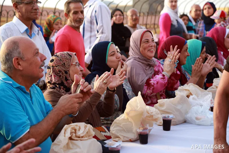 Egyptians gather around an Iftar table as they wait to break their daytime fast, during the Muslim holy month of Ramadan, in Egypt s Mediterranean city of Alexandria, Friday, June 26, 2015. Alexandria is seeking to enter...