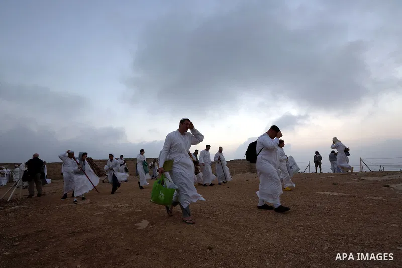 Members of the Samaritan sect pray atop Mount Gerizim near the West Bank city of Nablus, after sunrise on 28 June 2015, as they celebrate the Shavuot festival, marking the giving of the Torah at Mount Sinai seven weeks a...