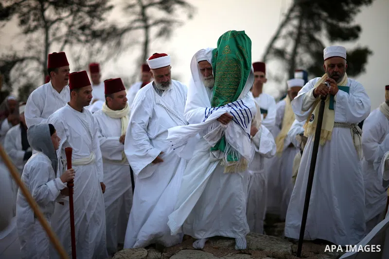 Members of the Samaritan sect pray atop Mount Gerizim near the West Bank city of Nablus, after sunrise on 28 June 2015, as they celebrate the Shavuot festival, marking the giving of the Torah at Mount Sinai seven weeks a...