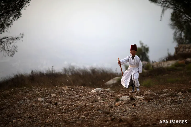 Members of the Samaritan sect pray atop Mount Gerizim near the West Bank city of Nablus, after sunrise on 28 June 2015, as they celebrate the Shavuot festival, marking the giving of the Torah at Mount Sinai seven weeks a...