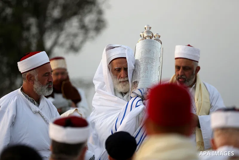 Members of the Samaritan sect pray atop Mount Gerizim near the West Bank city of Nablus, after sunrise on 28 June 2015, as they celebrate the Shavuot festival, marking the giving of the Torah at Mount Sinai seven weeks a...