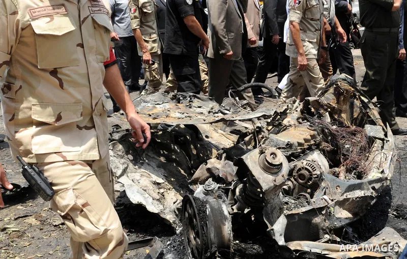 Egyptians gather at the site of a bomb that targeted the convoy of the Egyptian state prosecutor, Hisham Barakat, in the capital Cairo on June 29, 2015. Egypt's state prosecutor was wounded when a powerful bomb hit his c...