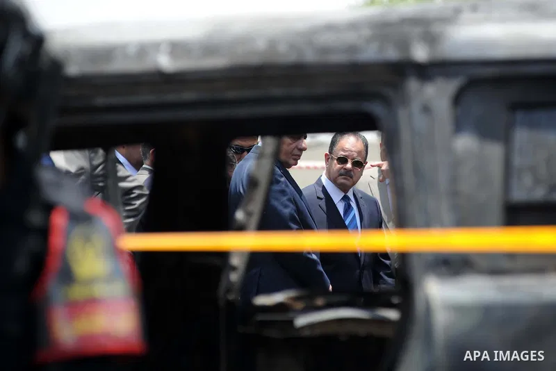 Egyptians gather at the site of a bomb that targeted the convoy of the Egyptian state prosecutor, Hisham Barakat, in the capital Cairo on June 29, 2015. Egypt's state prosecutor was wounded when a powerful bomb hit his c...