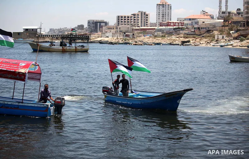 Palestinians riding boats hold Palestinian flags during a protest against the Israeli blocking of a boat of foreign activists from reaching Gaza, at the Seaport of Gaza City June 29, 2015. Israel said on Monday it had bl...