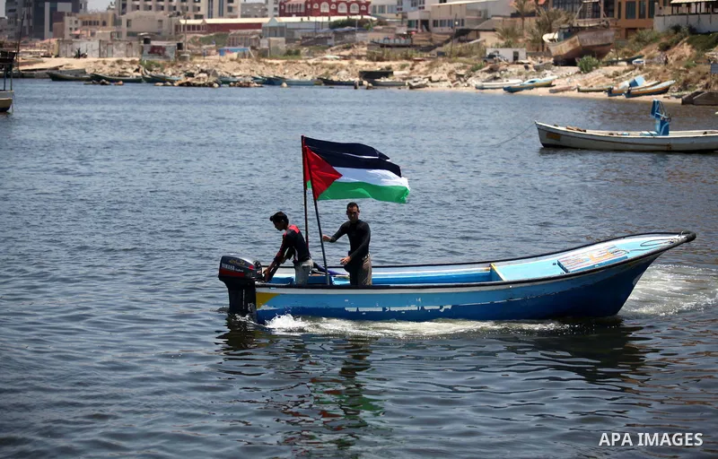 Palestinians riding boats hold Palestinian flags during a protest against the Israeli blocking of a boat of foreign activists from reaching Gaza, at the Seaport of Gaza City June 29, 2015. Israel said on Monday it had bl...