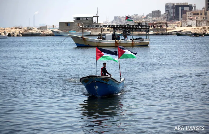Palestinians riding boats hold Palestinian flags during a protest against the Israeli blocking of a boat of foreign activists from reaching Gaza, at the Seaport of Gaza City June 29, 2015. Israel said on Monday it had bl...