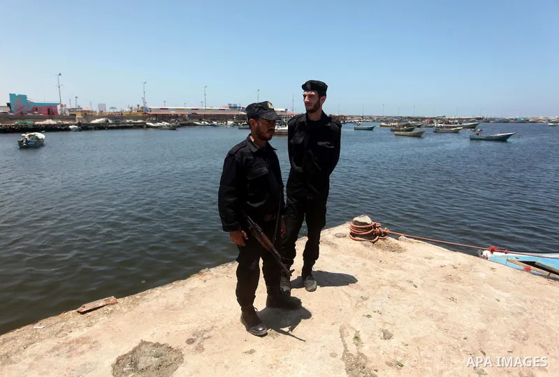 Palestinian police officers stands guard during a protest against the Israeli blocking of a boat of foreign activists from reaching Gaza, at the Seaport of Gaza City June 29, 2015. Israel said on Monday it had blocked a...