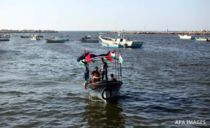 Palestinians riding boats hold Palestinian flags during a protest against the Israeli blocking of a boat of foreign activists from reaching Gaza, at the Seaport of Gaza City June 29, 2015. Israel said on Monday it had bl...