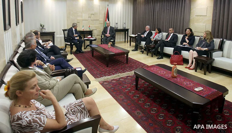 Palestinian Prime Minister Rami Hamdallah meets with Italian Foreign Minister Paulo Jantelaun, in the West Bank city of Ramallah on June 29, 2015. Photo by Prime Minister Office