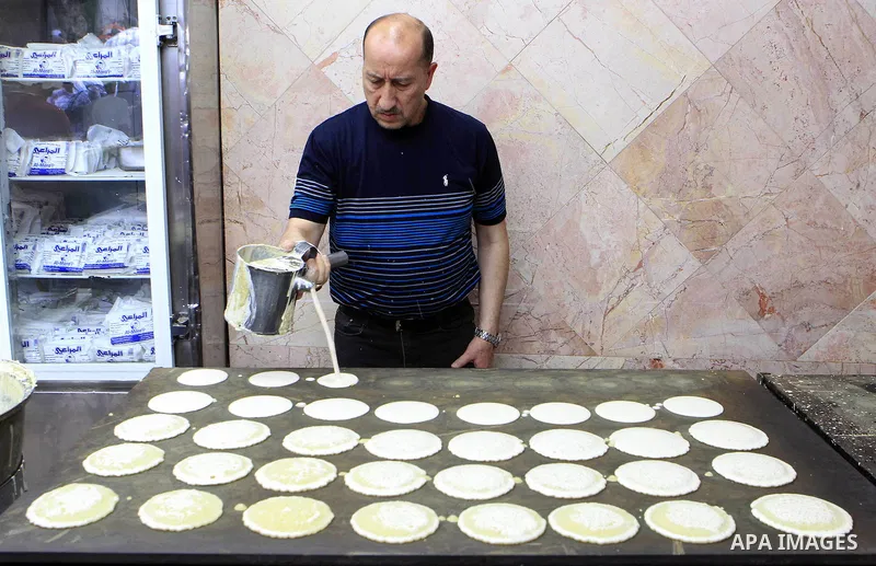 A Palestinian man prepares traditional pancakes known as ''Qatayef'' on the holy month of Ramadan, in Jerusalem's old city on June 29, 2015. During Ramadan, Muslim believers abstain from eating, drinking, smoking and hav...