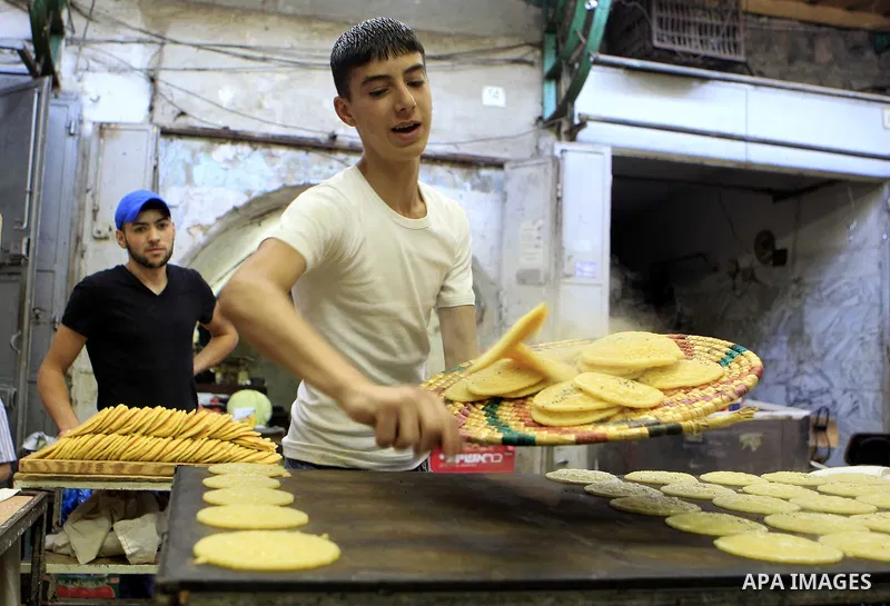 A Palestinian man prepares traditional pancakes known as ''Qatayef'' on the holy month of Ramadan, in Jerusalem's old city on June 29, 2015. During Ramadan, Muslim believers abstain from eating, drinking, smoking and hav...