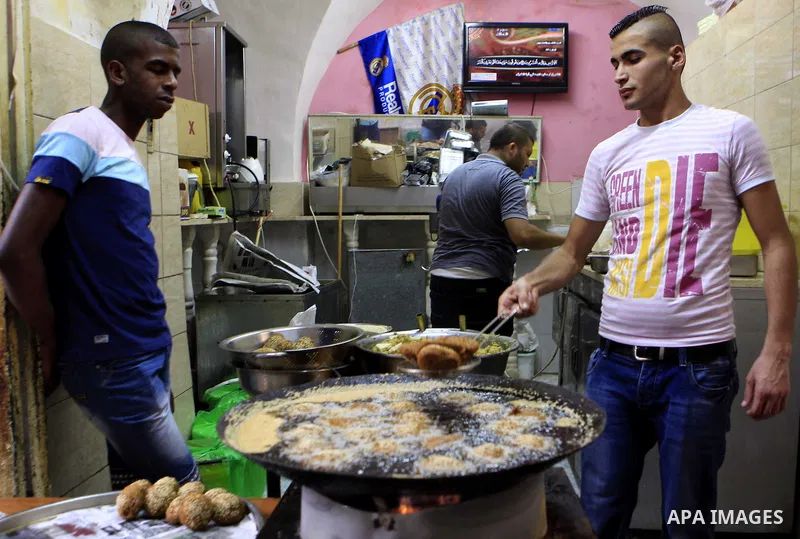 A Palestinian man sells falafel at his shop on the holy month of Ramadan, in Jerusalem's old city on June 29, 2015. During Ramadan, Muslim believers abstain from eating, drinking, smoking and having sex from dawn until s...