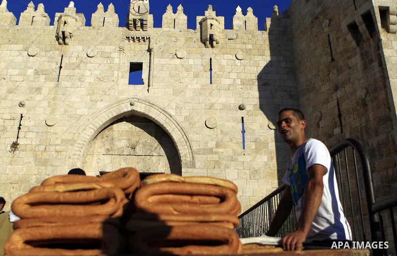 A Palestinian man sells bread in front of Damascus gate on the holy month of Ramadan, in Jerusalem's old city on June 29, 2015. During Ramadan, Muslim believers abstain from eating, drinking, smoking and having sex from...