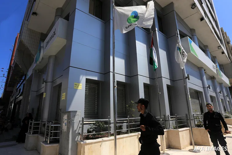 Palestinian police officers stand guard in front of closed doors of Jawwal headquarter in Gaza City on June 30, 2015. Palestinian police in Gaza closed of Jawwal headquarter this morning by order attorney general in Gaza...