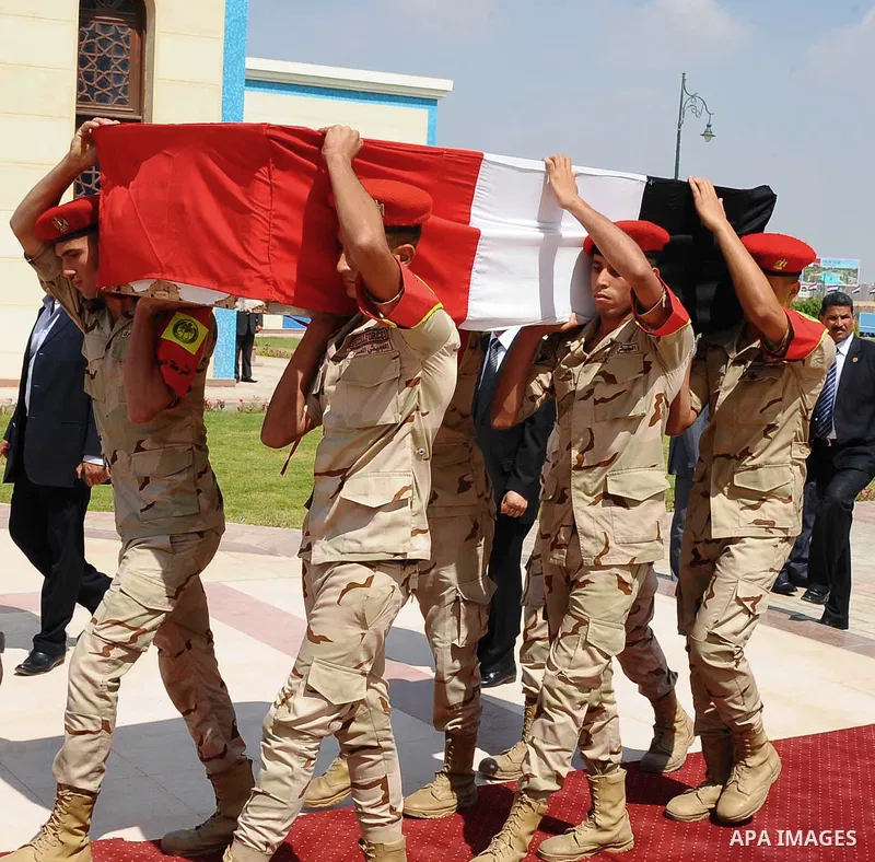 Egyptian military pallbearers carry the flag draped coffin of Hisham Barakat, the top judicial official in charge of overseeing the prosecution of thousands of Islamists, including former President Mohammed Morsi, at his...