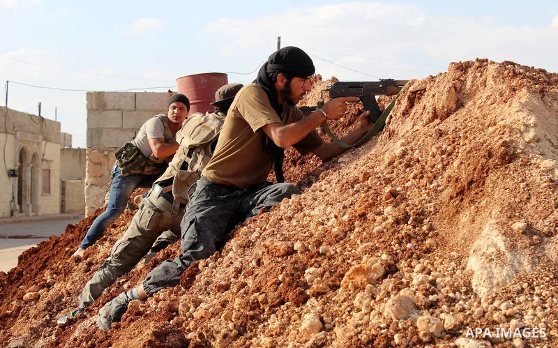 Fighters from the Free Syrian Army's Al-Tawhid Brigade take their position at the border with Dabiq city, the stronghold of the ISIS fighters, in the Mare' city in the north of Aleppo, on June 30, 2015. Photo by Ameer al...