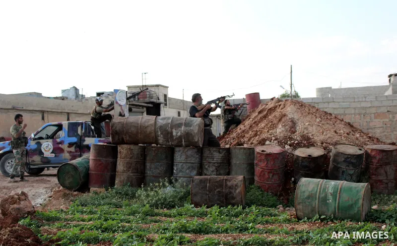 Fighters from the Free Syrian Army's Al-Tawhid Brigade take their position at the border with Dabiq city, the stronghold of the ISIS fighters, in the Mare' city in the north of Aleppo, on June 30, 2015. Photo by Ameer al...